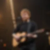 Ed Sheeran performing on stage with vibrant lights